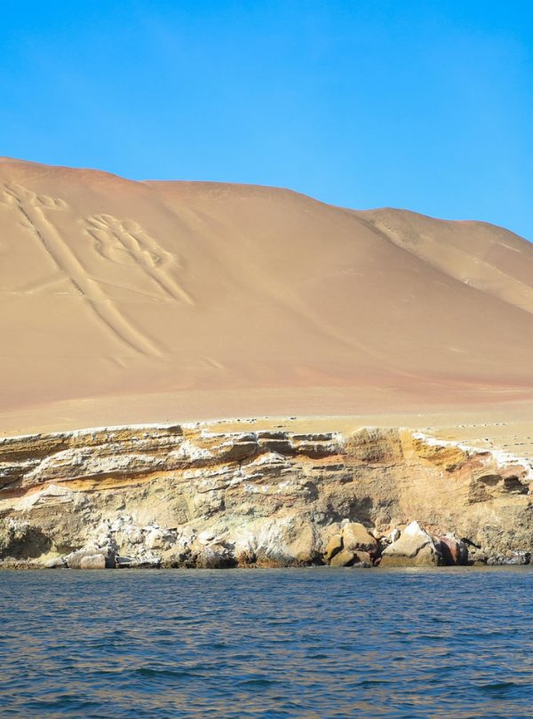 The Paracas Candelabro, a massive geoglyph etched into a sandy hill overlooking the Pacific Ocean in Peru.