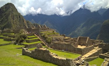 Ancient Inca citadel of Machu Picchu surrounded by lush green mountains and misty clouds in Peru