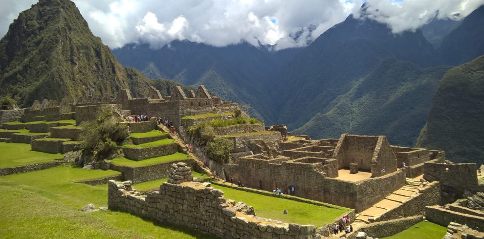 Ancient Inca citadel of Machu Picchu surrounded by lush green mountains and misty clouds in Peru