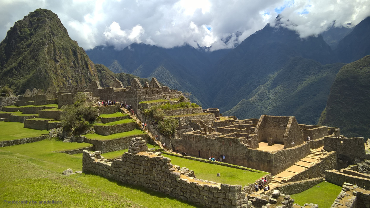 Ancient Inca citadel of Machu Picchu surrounded by lush green mountains and misty clouds in Peru