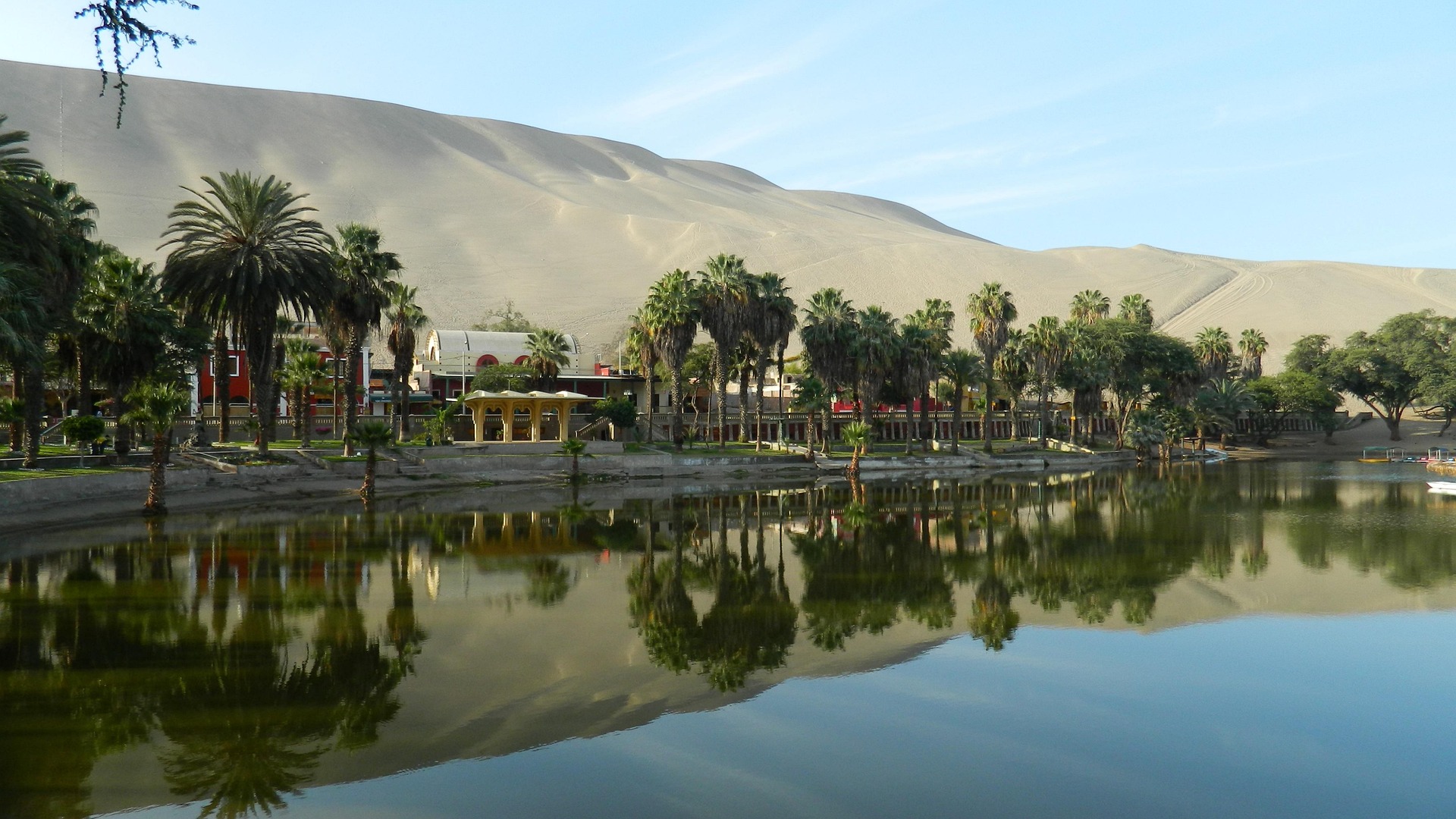 The peaceful lagoon and palm trees of Huacachina oasis in southern Peru.